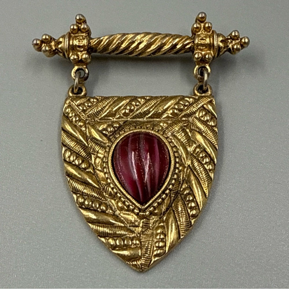 Vintage 1928 Gold Dangle Shield Brooch with Red Stone Accent